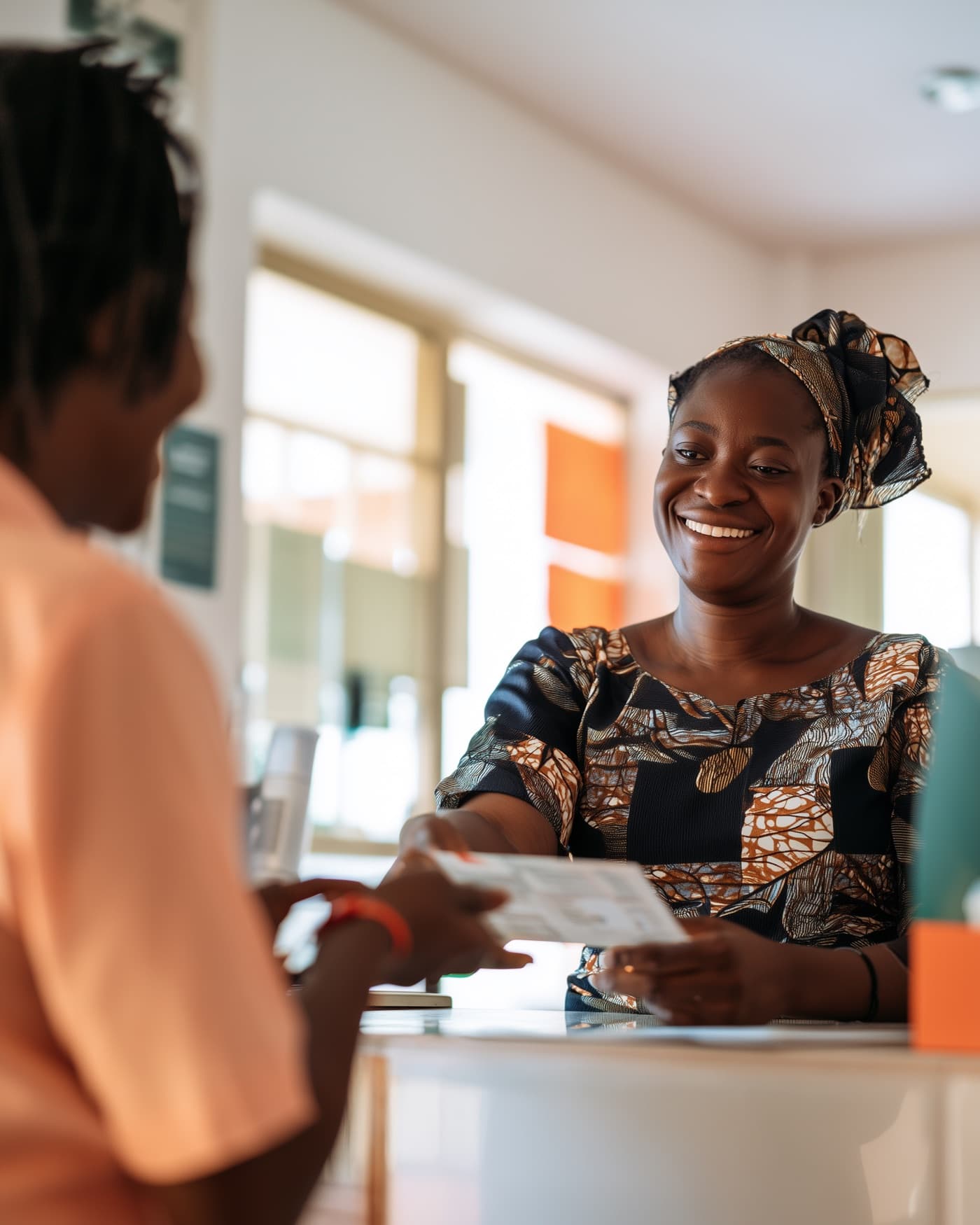 A patient smiling as she collects her results at a reception counter